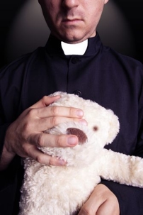 picture of priest holding a toy