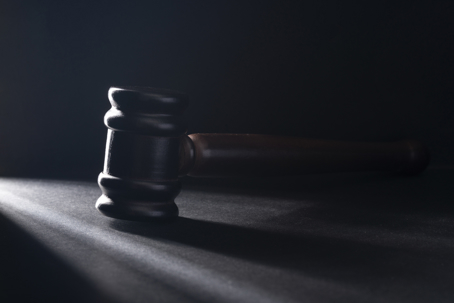 wooden gavel on the black table.
